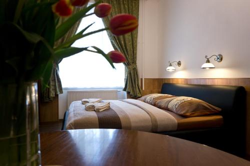 a bedroom with a bed with a table and a window at Apartment Karla Capka Street in Karlovy Vary