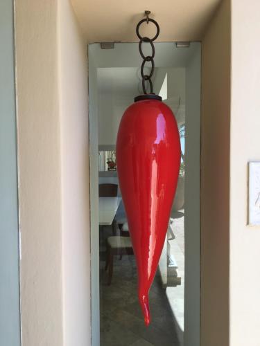 a large red vase hanging from a chain at Hotel Orsa Maggiore in Anacapri
