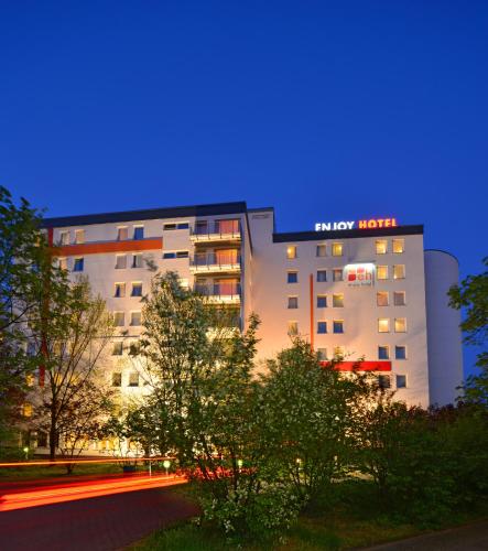 a hotel with a blue sign on top of it at enjoy hotel Berlin City Messe in Berlin