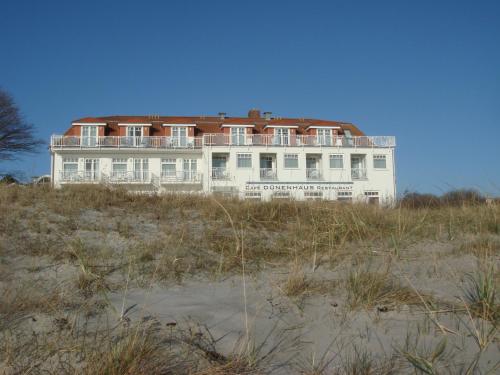 a large white house on the beach at Strandhotel Dünenhaus in Juliusruh