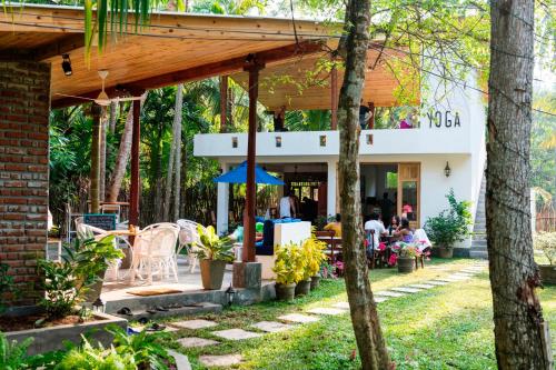 a patio of a house with a table and chairs at Salt House in Hiriketiya