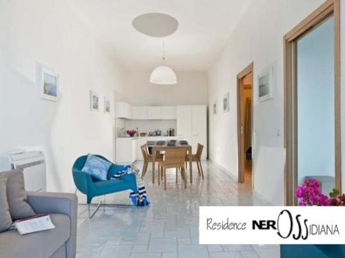 a living room with a blue chair and a table at NerOssidiana in Acquacalda