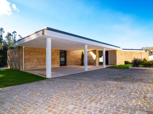 a house with a stone driveway at Casa da Luz in Vieira do Minho