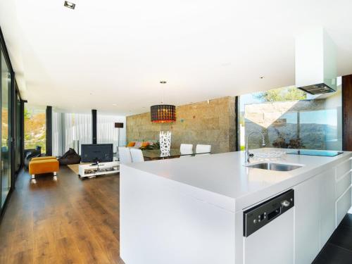a kitchen and living room with a white counter top at Casa da Luz in Vieira do Minho