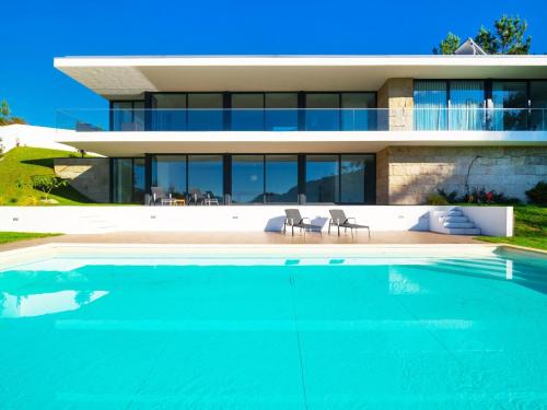 a house with a swimming pool in front of a house at Casa da Luz in Vieira do Minho
