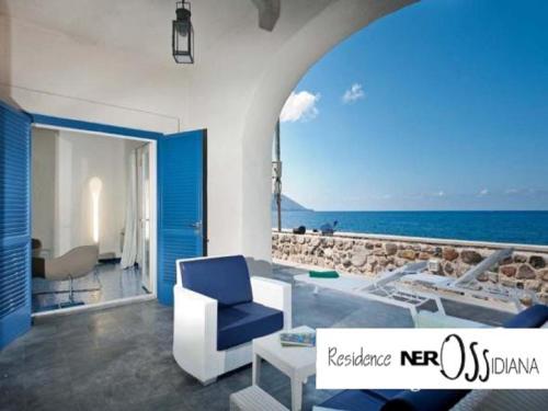 a living room with a view of the ocean at NerOssidiana in Acquacalda