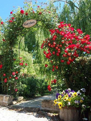 a garden with flowers and a sign that reads garden at Bigotti in Fano