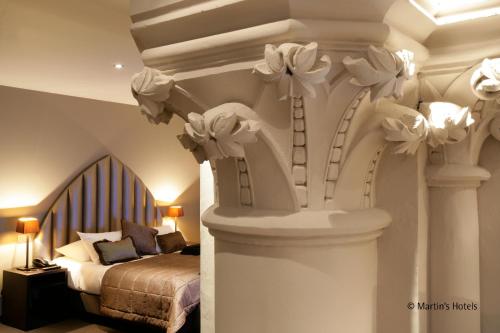 a bedroom with a bed with flowers on the ceiling at Martin's Patershof in Mechelen