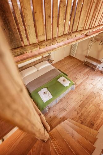 an overhead view of a bed in an attic at Locanda del Silenzio Hotel in Macra