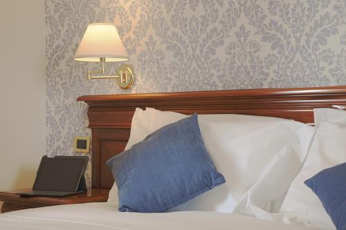 a bedroom with a bed with a laptop on it at Relais Villa Giuliana in Licata