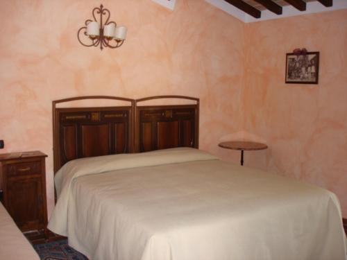 a bedroom with a bed and a chandelier at Agriturismo Borgo Montecucco in Todi