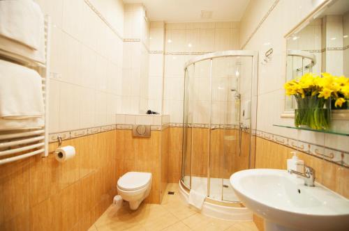 a bathroom with a toilet and a sink at Hotel Artur in Kraków