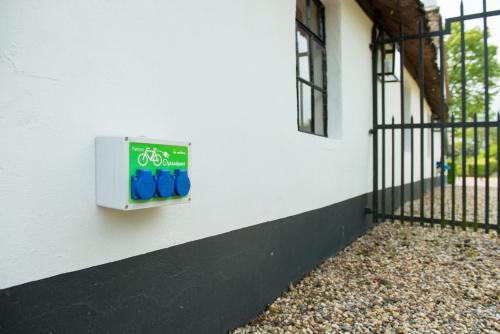 a sign on the side of a building with a bike on it at De Heeren van Tuil in Tuil