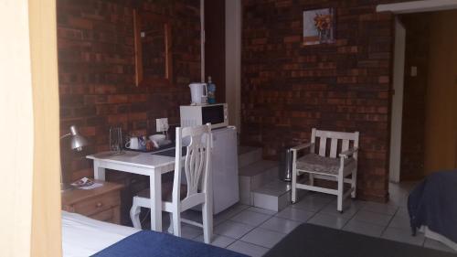 a small kitchen with a table and a microwave at The Highland Inn in Bethlehem