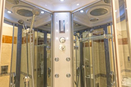 a shower stall in a room with glass doors at Certosa Suite in Naples