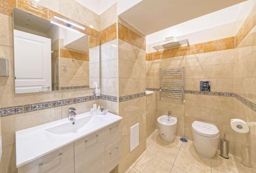 a bathroom with a sink and a toilet at Certosa Suite in Naples