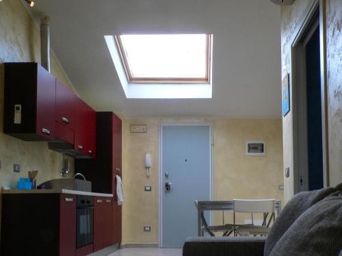 a kitchen with a skylight in the ceiling of a room at La Mansarda Colorata in Rio Marina