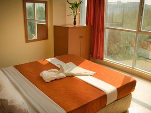 a bed in a room with a large window at Praasad Paradise in Cox's Bazar