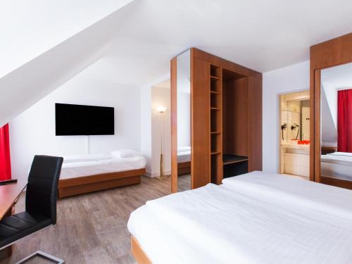 Postel nebo postele na pokoji v ubytování DORMERO Hotel Dresden Airport