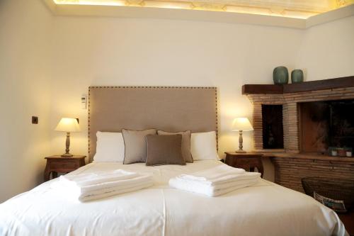 a bedroom with a large white bed with two pillows at Al Palazzetto in Tivoli