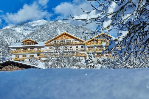 a hotel in the mountains with snow on the ground at Romantik Alpenhotel Waxenstein in Grainau