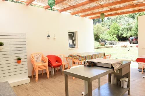 a patio with a table and some chairs and a table at Horta do Vale - Nature House in Odeceixe
