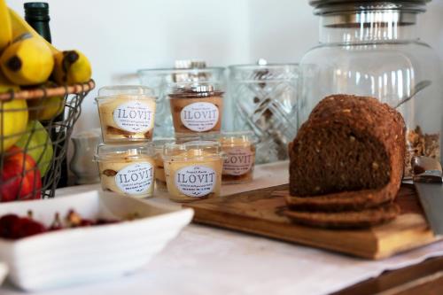 a table with a loaf of bread and jars of honey at Al Palazzetto in Tivoli