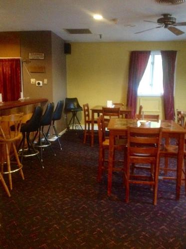 a dining room with wooden tables and chairs at Hotel Terrace in Millinocket
