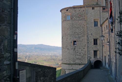 a large stone building with a tunnel next to it at La Doccia in Anghiari