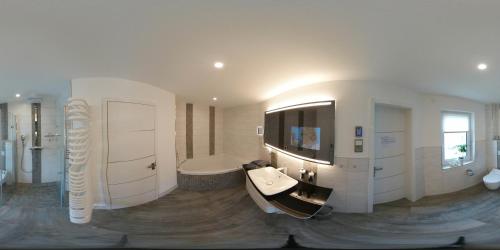 a large bathroom with a tub and a sink at Ferienhaus Leuchtfeuer in Ostseebad Sellin