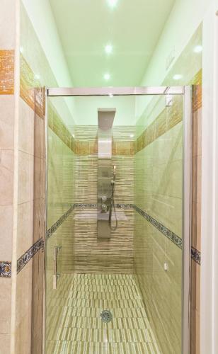 a shower with a glass door in a bathroom at Certosa Suite in Naples