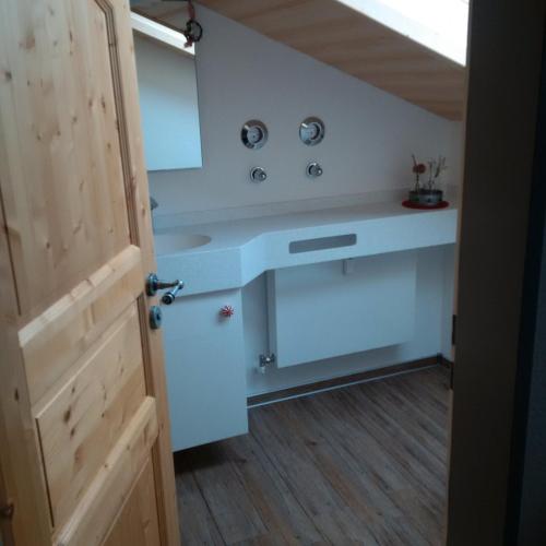 a bathroom with a sink and a mirror at Ferienwohnung Hörnerblick in Fischen