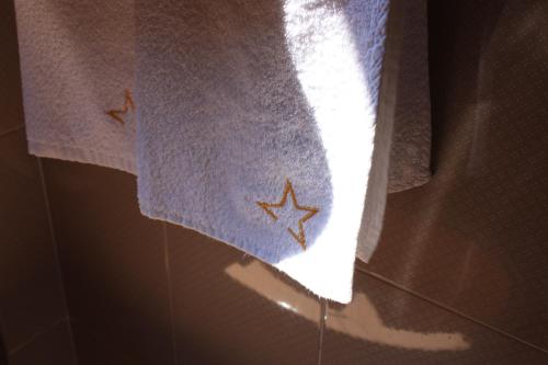 a towel with stars on it hanging from a window at Moonlight- Bedbluesky in Perinaldo