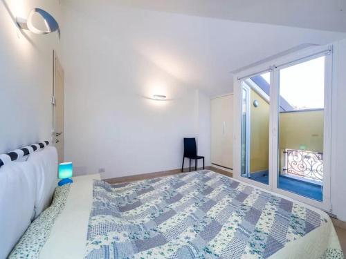 a bedroom with a bed and a large window at Libra Flexyrent in Rapallo