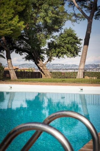 a view of a swimming pool with trees at Hôtel Club Port La Galère in Théoule-sur-Mer