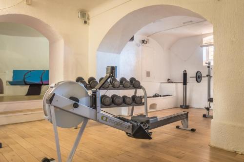 a gym with a bunch of weights in a room at Hôtel Club Port La Galère in Théoule-sur-Mer