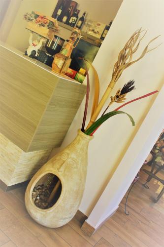 a vase with a plant in it sitting on the floor at Florivana Boutique Hotel in San Pietro in Cariano