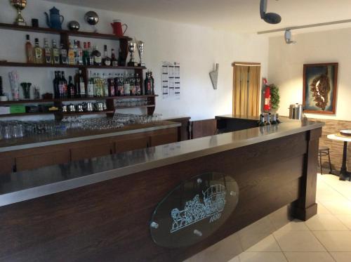 a bar with a wooden counter with a sign on it at Hotel Restaurant de la Poste in Aullène