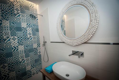 a bathroom with a white sink and a mirror at Luxury Apartments Manarola by Arbaspàa in Manarola