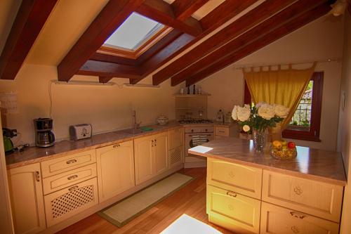 a large kitchen with white cabinets and a skylight at Casa Meraviglia in Tremezzo