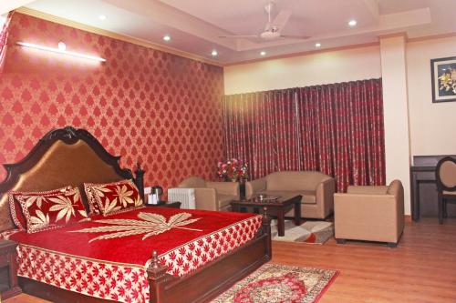 a bedroom with a bed and a living room at Hotel Shikhar & Restaurant in Almora