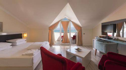 a living room with a bed and a table at Orka Boutique Hotel in Fethiye
