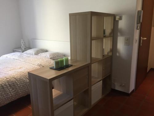 a bedroom with a bed and a dresser with candles on it at Cà Dela in Moghegno