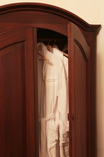 a closet with white clothes hanging in it at Al Palazzetto in Tivoli