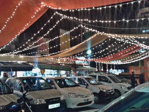 a bunch of cars parked in a parking lot with lights at Hotel Shikhar & Restaurant in Almora
