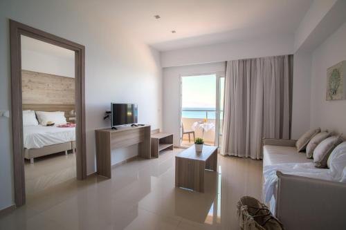 a living room with a couch and a bed and a mirror at Orpheus Studios in Kos Town