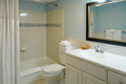 a bathroom with a toilet and a sink and a tub at Sea Crest Inn in Cape May