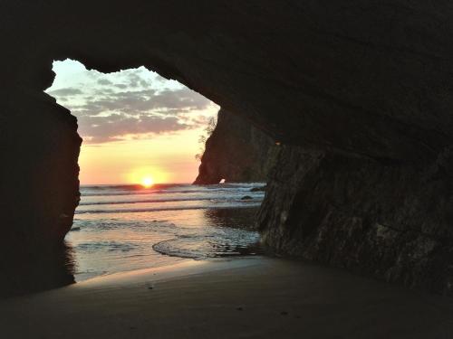 a sunset seen through a cave on the beach at Las Brisas del Sur in Ojochal