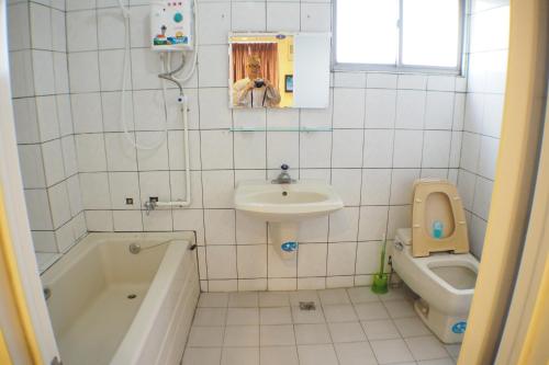 y baño con lavabo, aseo y bañera. en Sun Moon Star Hostel en Budai