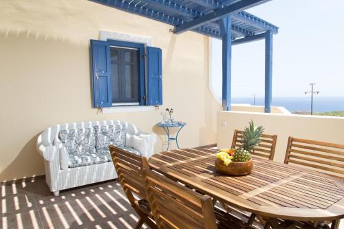 a living room with a table and a couch at Maison Marilia in Akrotiri